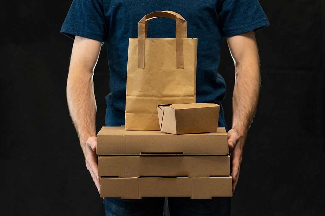 A man carrying takeaway delivery packages